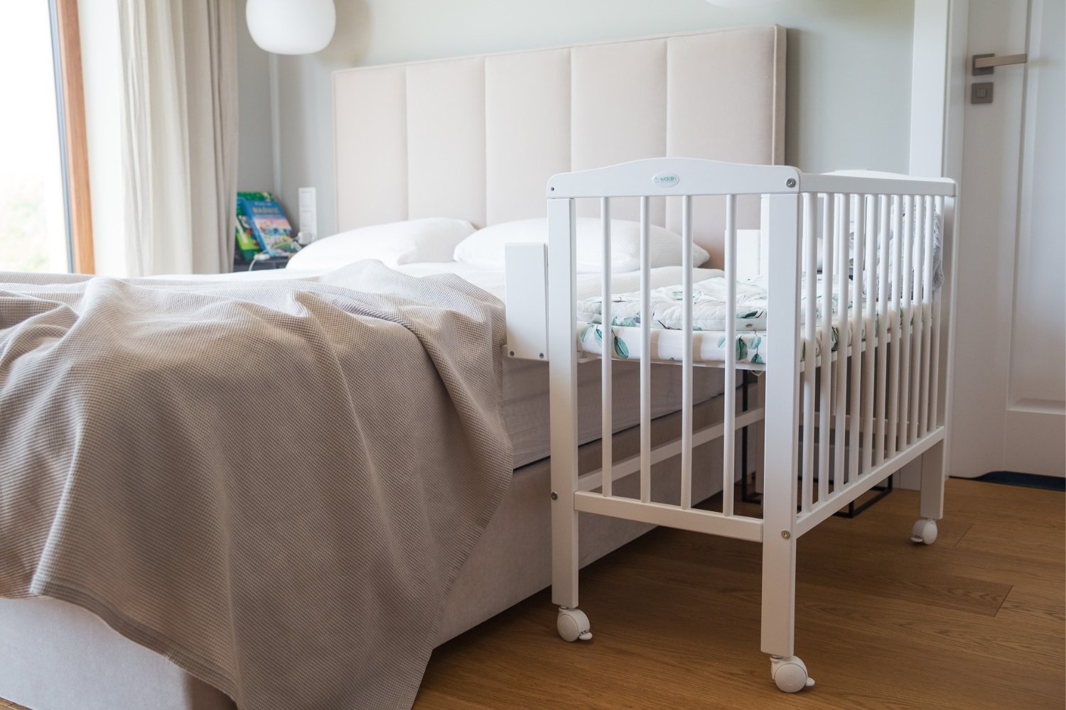 White Bedside Crib with Mattress and Bed Bumper